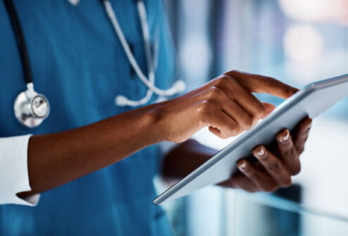 Cropped shot of a doctor using a digital tablet in a hospital